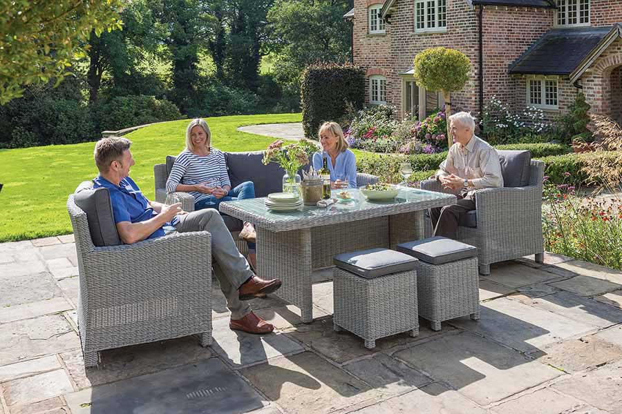 People dining on Kettler luxury garden furniture